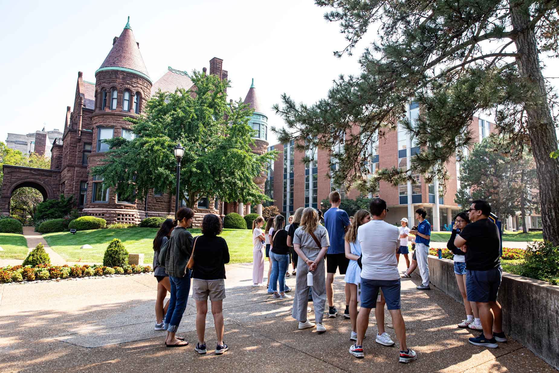Visiting families take a tour of campus, led by a student tour guide