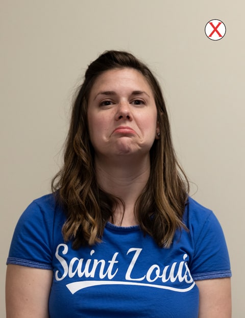 Example of bad facial expression A headshot of a woman wearing a SLU t-shirt. She is frowning deeply at the camera.