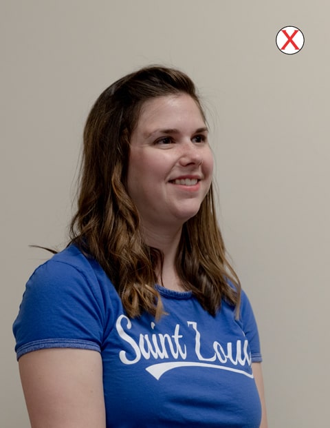 Example of bad position headshot of a woman wearing a SLU t-shirt. Her head and body are angled to the right and away from the camera.