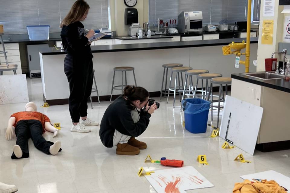 SLU student takes photos at mock crime scene