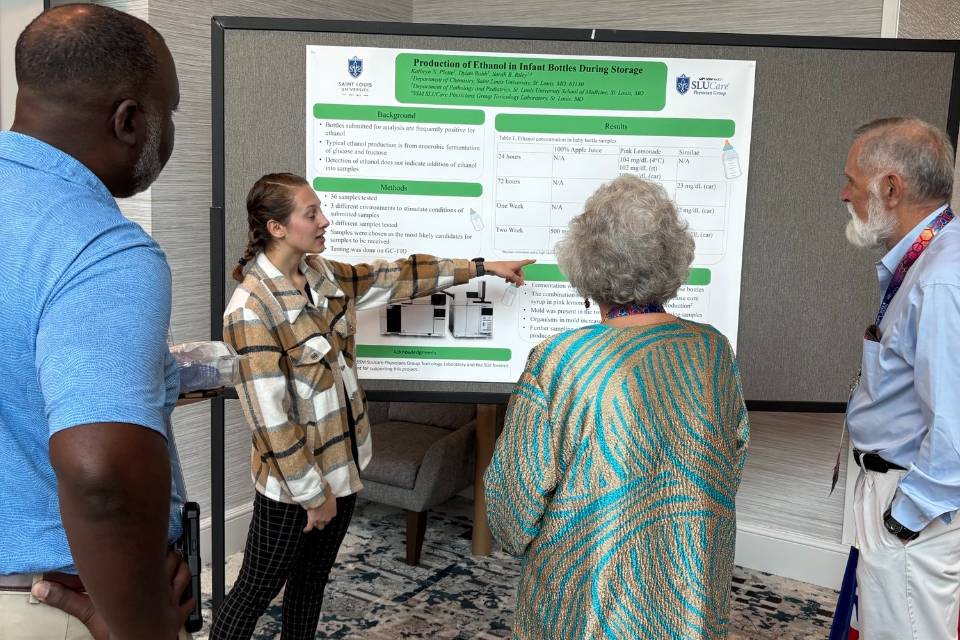 student shows faculty poster presentation