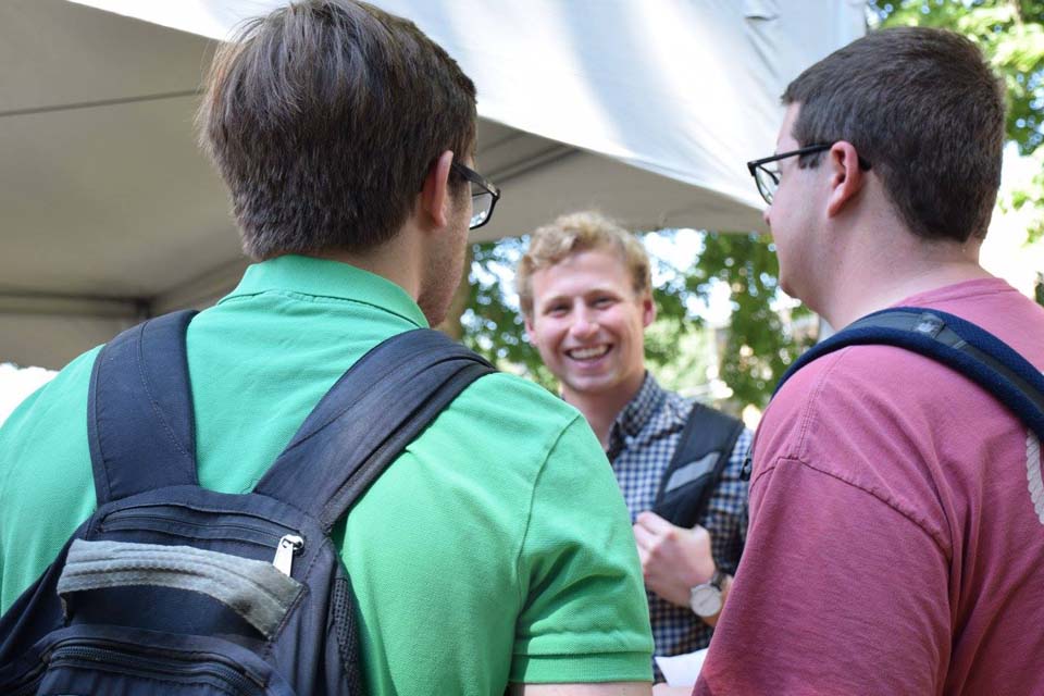 Students talking Three students in a group outdoors talking