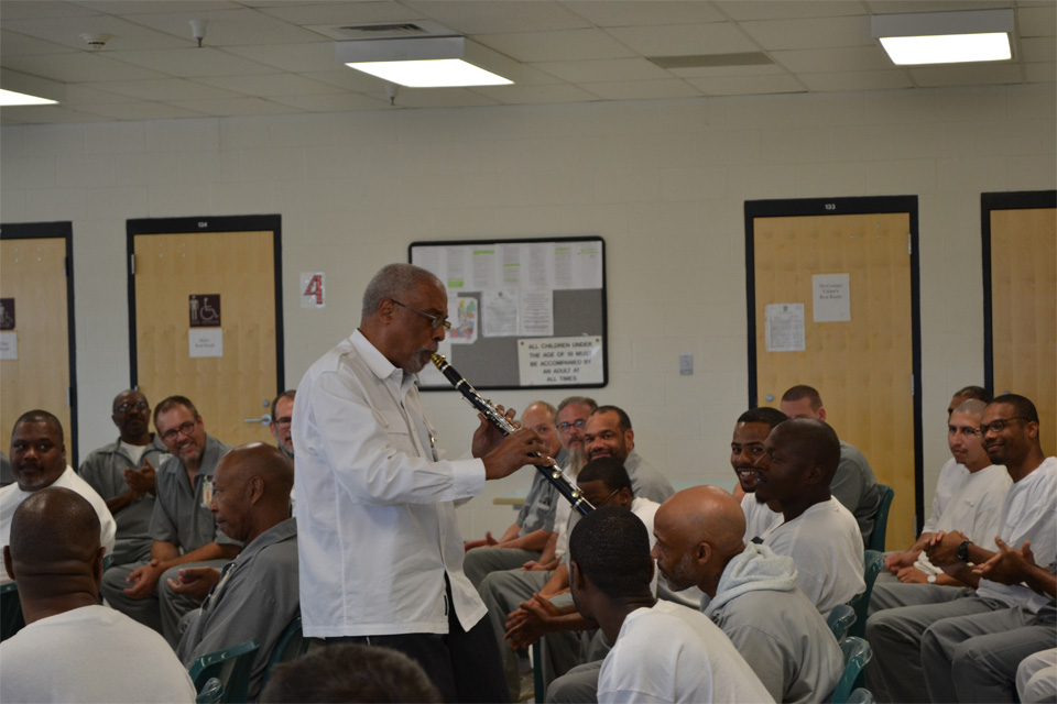 Man plays clarinet in music class Man plays clarinet in music class