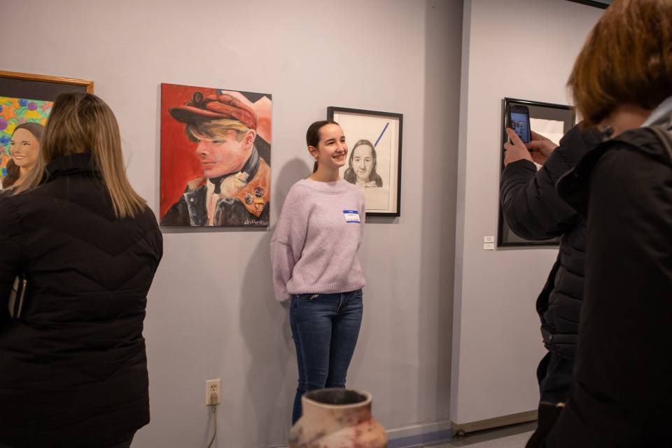 A student artist poses at SEEDS