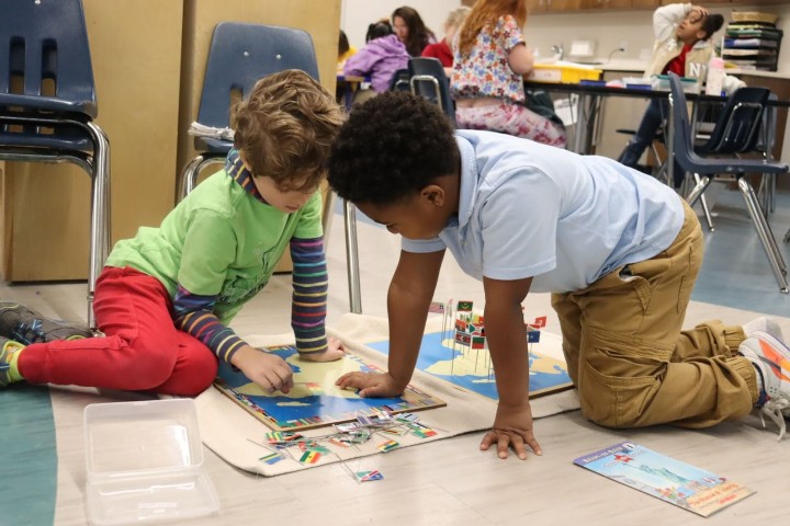City Garden Kids children in a classroom looking at a map