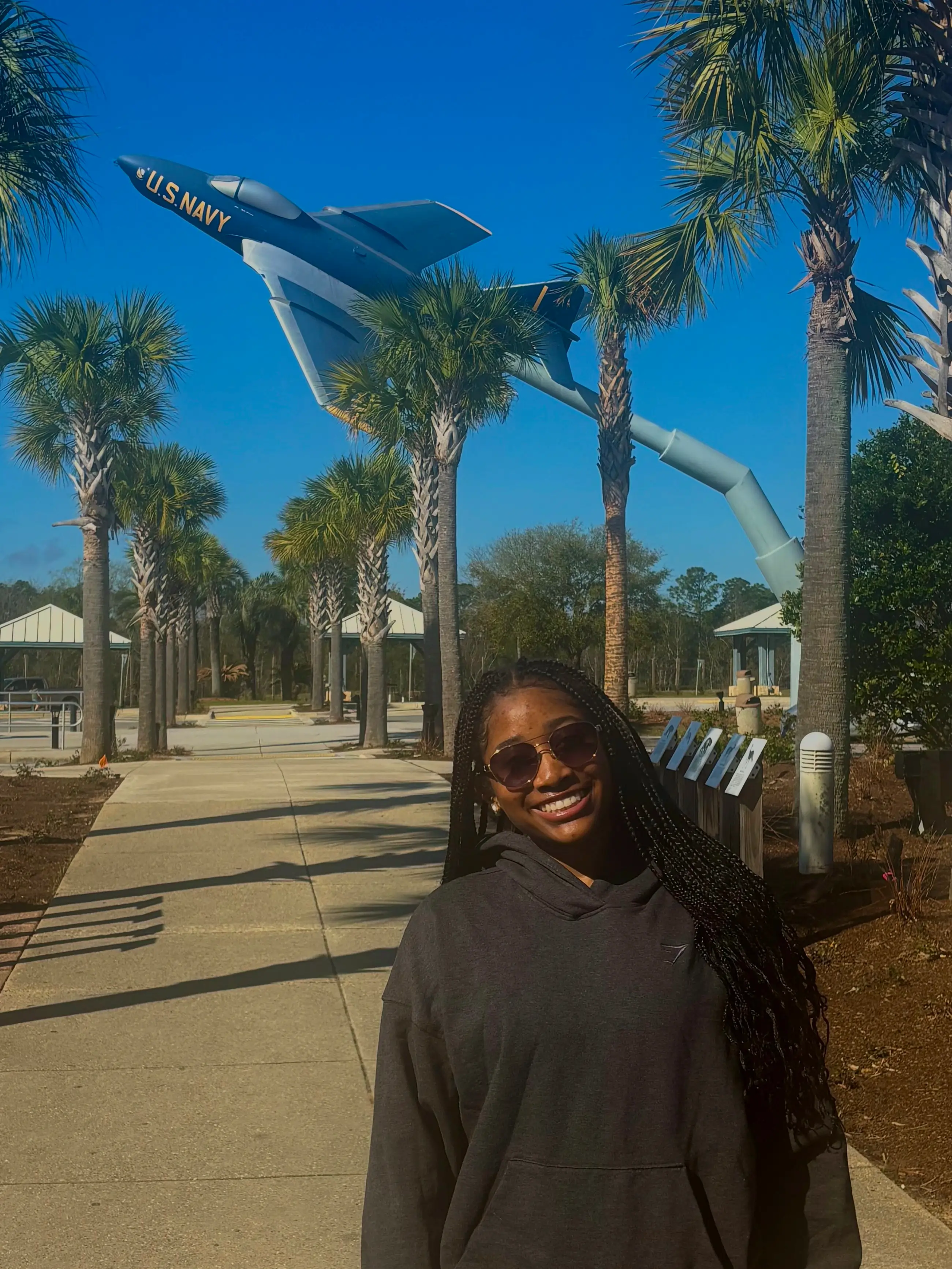 Naiyah is standing in front of a display of a rocket.