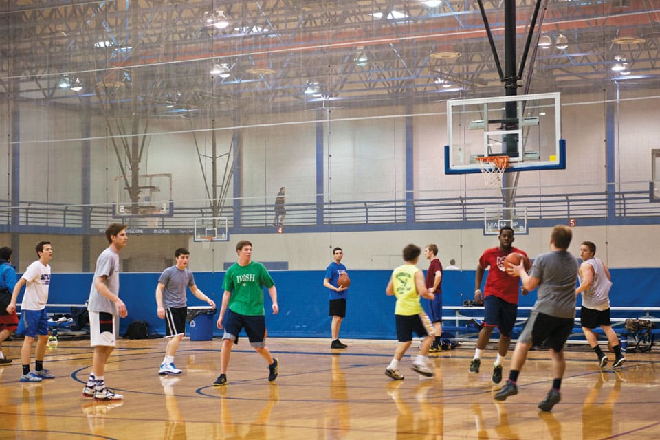 Intramural basketball in the Simon Rec Center Students play basketball in a gymnasium.