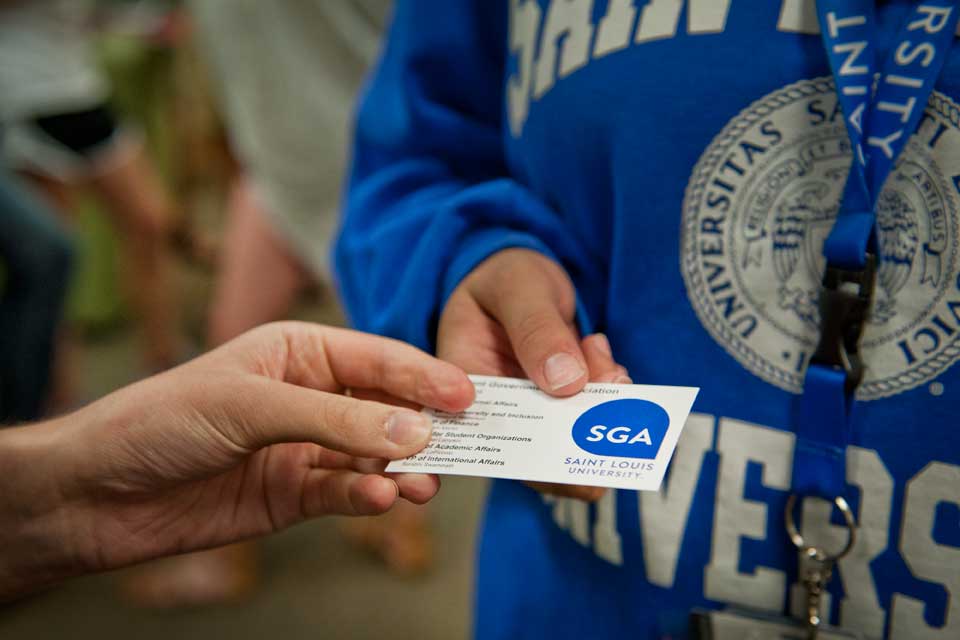 S G A Student holding a SGA business card