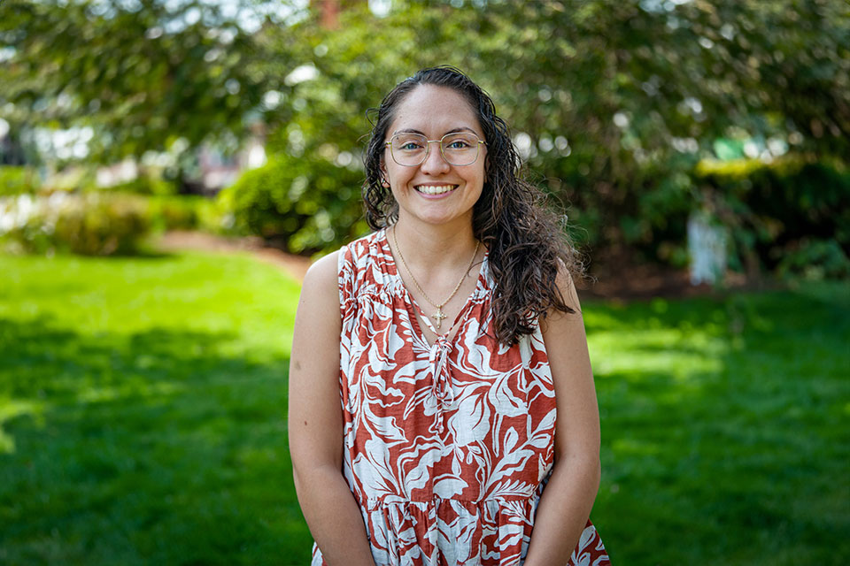 Lupe Murillo Wink Photograph of Lupe Murillo Wink standing outside in a grassy area with trees in the background