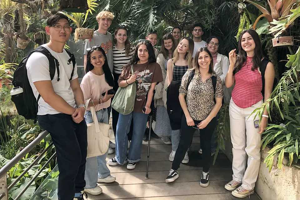 Royal Botanical Garden Students and professor stand on a walkway surrounded by lush plants.