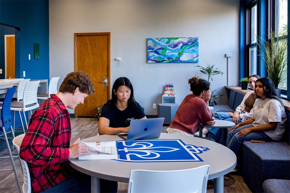A group of students studying and decompressing in the wellness space A group of students studying and decompressing in the wellness space