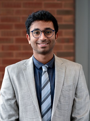 Nitin Katakam Young, Indian man in grey suit and glasses