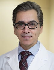 Headshot of Hossein Asghari, wearing white coat Headshot of Hossein Asghari