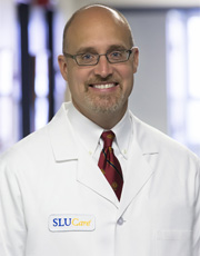 Headshot of Bradley Davitt, wearing white coat and smiling Headshot of Bradley Davitt