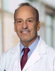 Headshot of Oscar Cruz, wearing white coat Headshot of Oscar Cruz