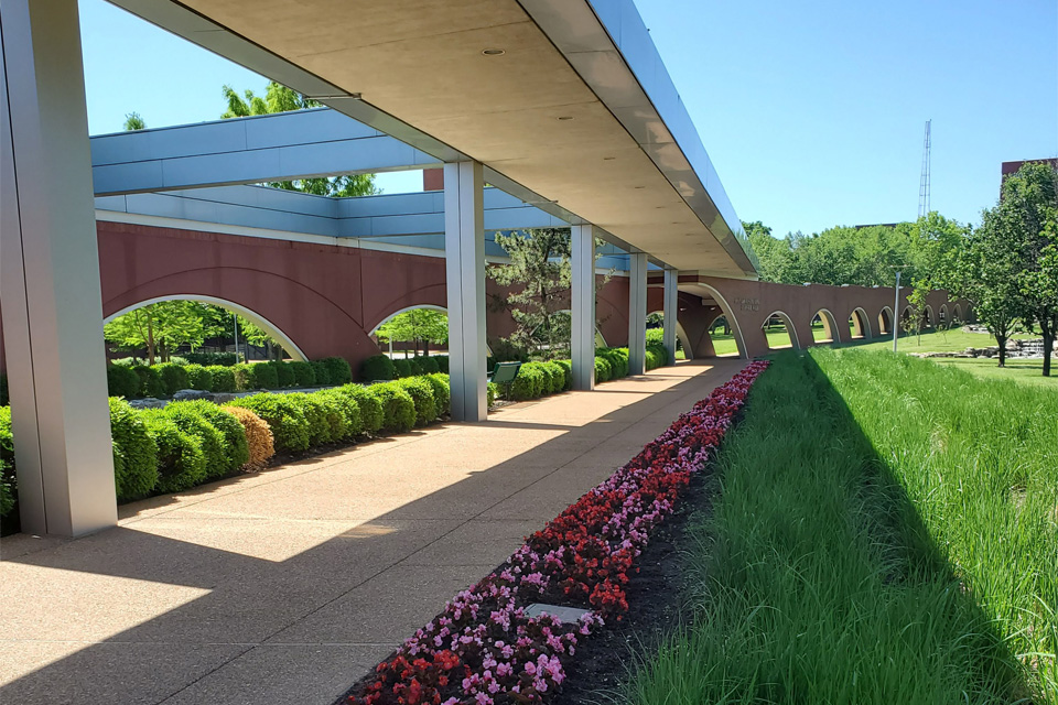 Picture of Doisy Tunnel A covered walkway lined by flowers and greenery.