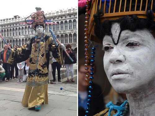 Maria Magdalena Campos-Pons performs as FeFa at the Venice Biennale in 2013. Photo by Marie Cieri. Dressed in an elaborate costume and with her skin painted white, Maria Magdalena Campos-Pons performs as FeFa at the Venice Biennale in 2013