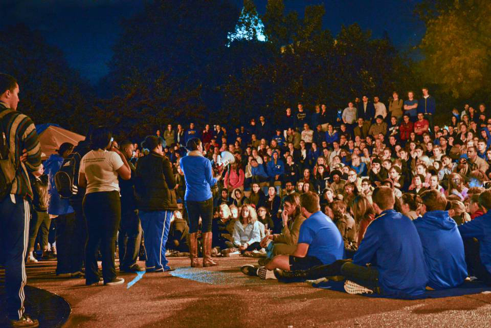 Occupy SLU Students crowd around the clock tower plaza while listening to a speaker on a microphone