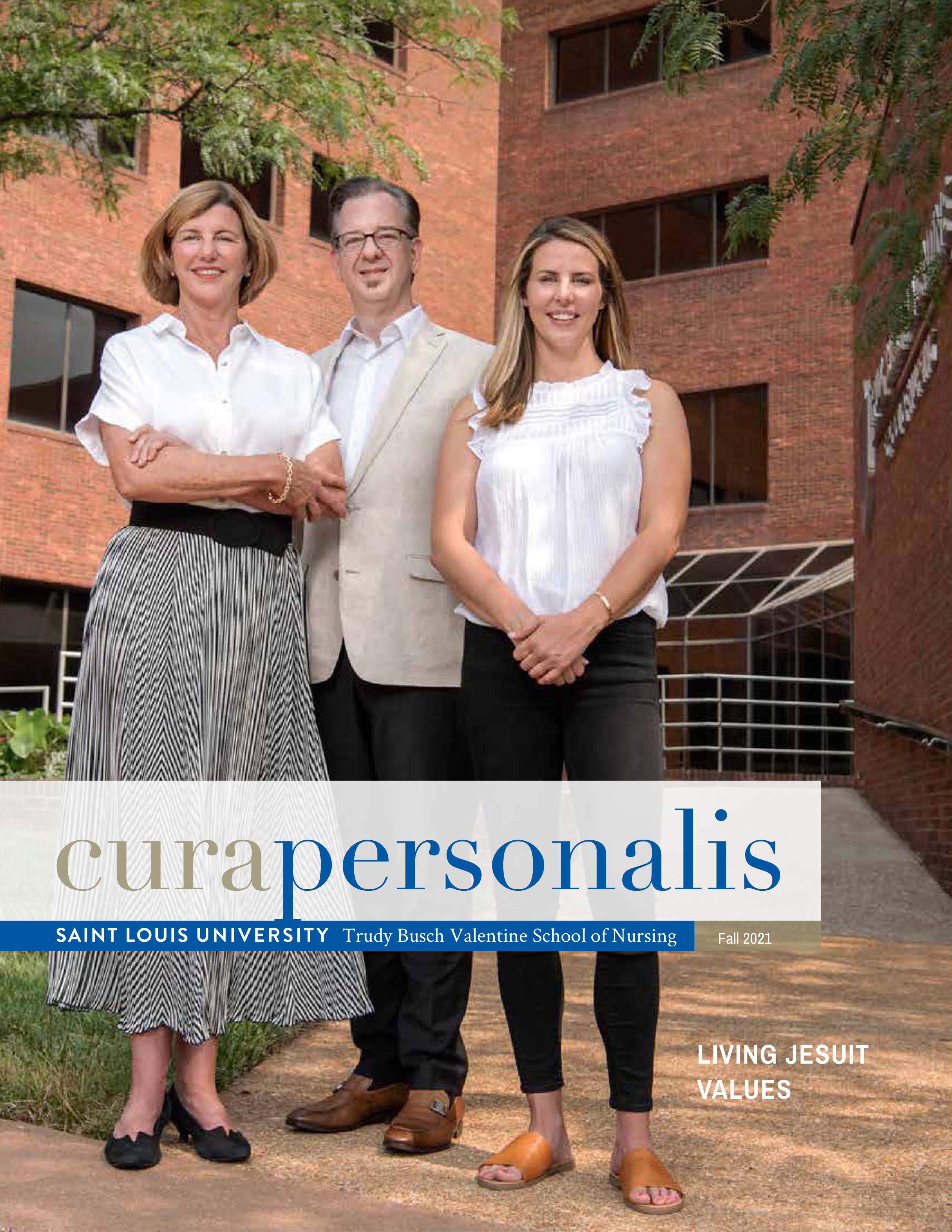 Cura Personalis 2021 The 2021 cover of cura personlis showing a three people posed outside the nursing school