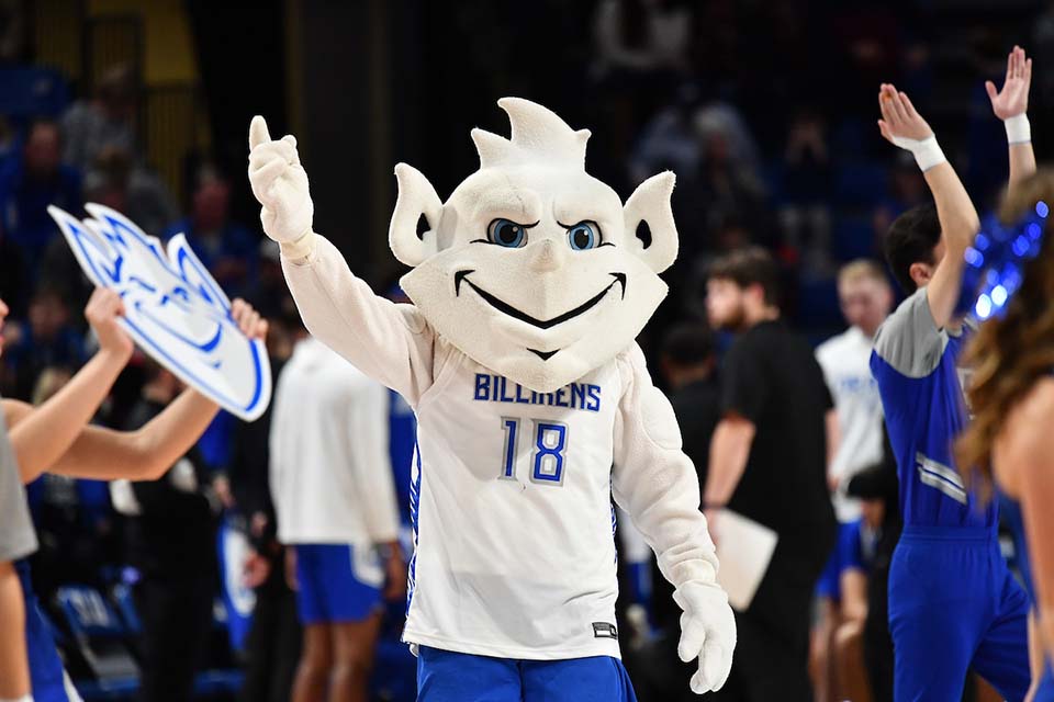 Billiken Macot Billiken Mascot outside inside a game at Chaifetz Arena with his arm raised