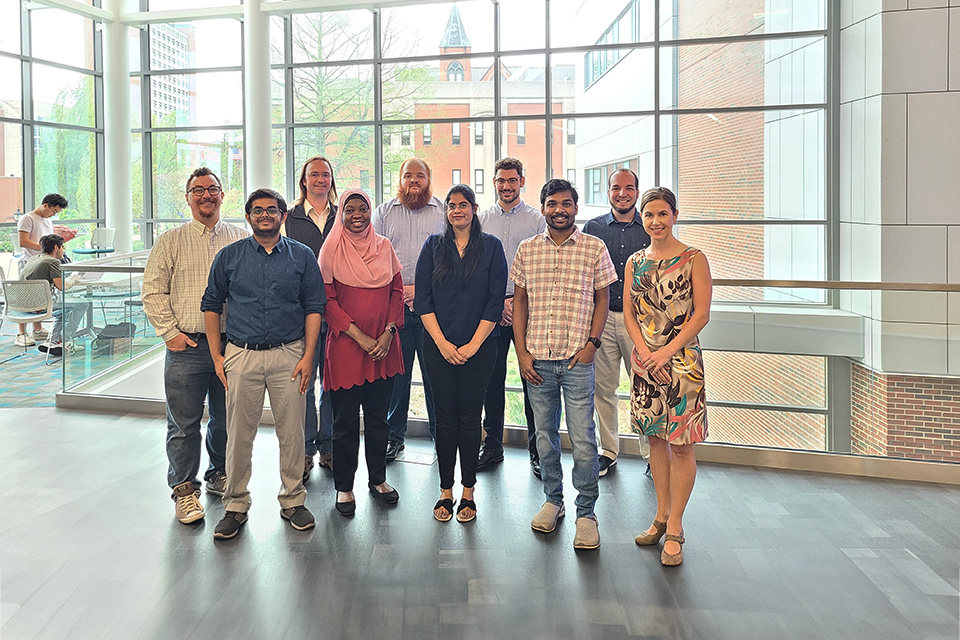 The Open Source with SLU team. The Open Source with SLU team poses for a photo while standing in two row.
