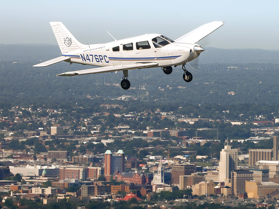 Piper Archer flying over campus Piper Archer flying over campus
